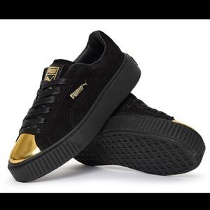 Puma gold and black sneakers